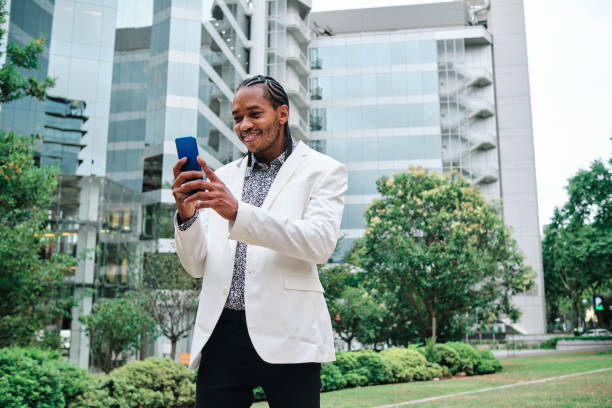 istock Cool african man using the mobile outdoors 1464727982
