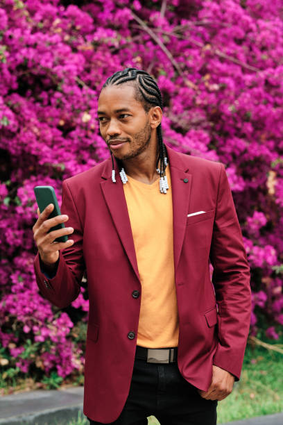 istock Handsome african stylish man using a mobile outdoors 1464727993