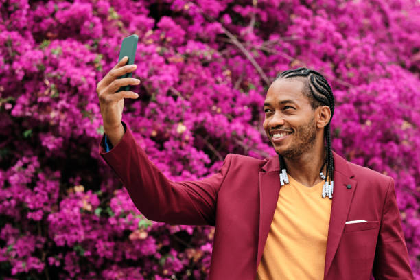 istock Cool african man taking a selfie in a garden 1464727994