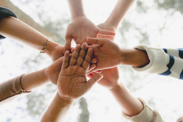 Group of people Shaking hands Low Angle View of young multiracial group of people Shaking hands sea of hands stock pictures, royalty-free photos & images