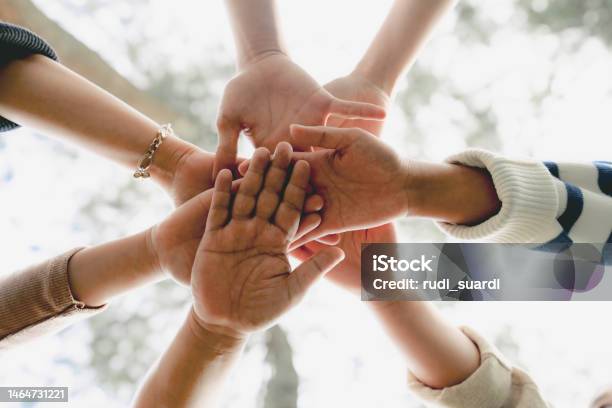 Group Of People Shaking Hands Stock Photo - Download Image Now - Circle, Teamwork, Wellbeing