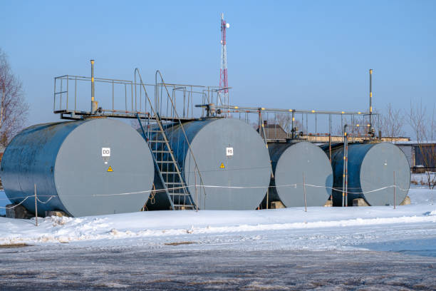 istock Four fuel storage tanks of different sizes in small farming 1464732076