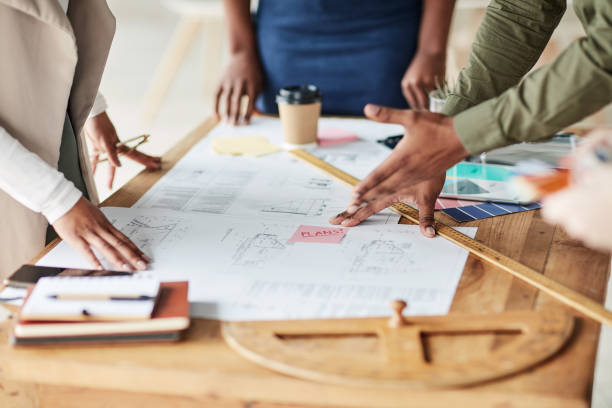 istock Hand, planning and interior, design and team in office for creative, collaboration and teamwork. Building, project and designer group with documents, blueprints and paper, layout and illustration 1464735820