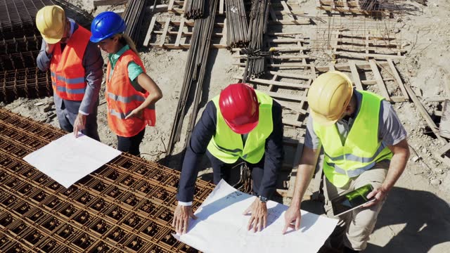 Group of contractors having a meeting at construction site.