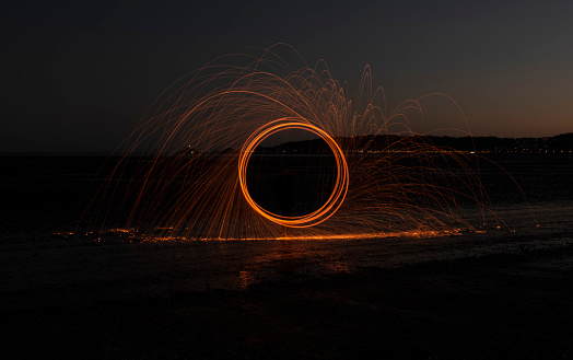 Burning wire wool image, circular light trails at night
