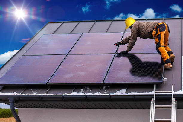 istock Solar panel installer installing solar panels on roof of modern house 1464738079