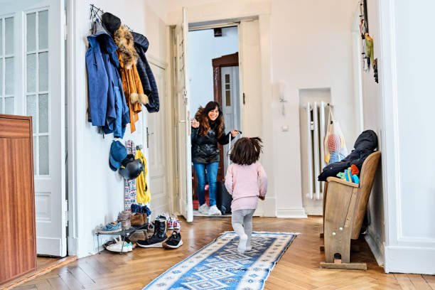 istock Daughter welcoming mother returning from trip in mudroom 1464739470