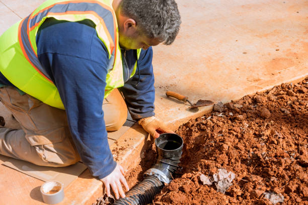 istock A plumber mounts the assembly for the drainage system for rainwater runoff 1464739937