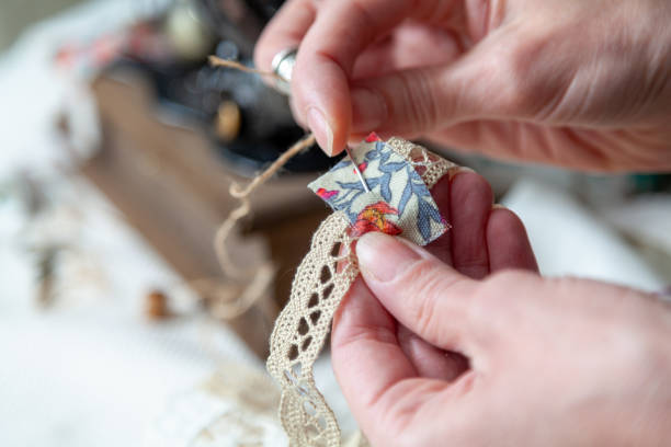 istock Hands of seamstress working with needle close-up 1464741629