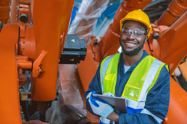 istock happy smiling engineer worker African black people work in factory industry 1464741860