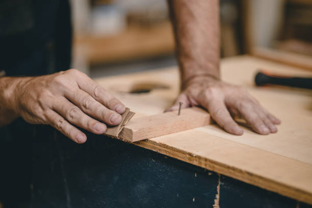 istock Professional Carpenter Joiner hand use sand paper making furniture. home builder diy projects authentic Handcraft Wood worker. 1464742537