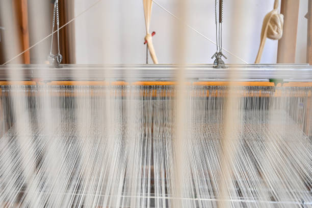 istock Traditional wooden loom with white weaving yarns 1464744528