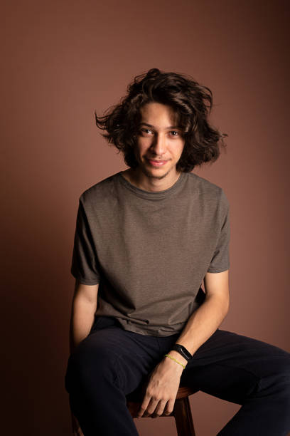 istock Handsome and happy young man sitting. 1464744624