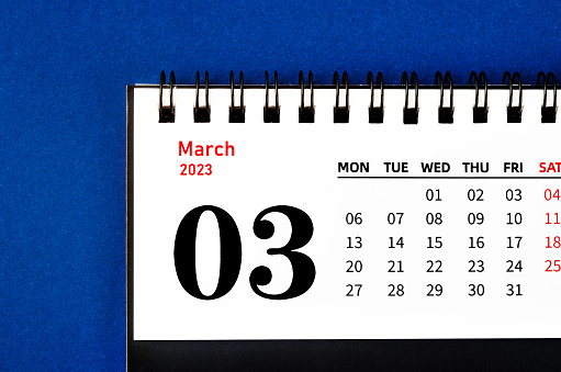 March 2023 Monthly desk calendar for 2023 year on blue background.