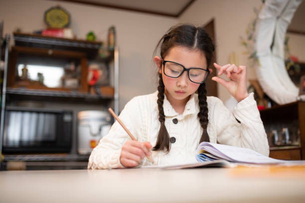 istock Girl with glasses studying seriously 1464746238