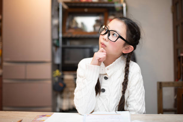 istock Girl wearing glasses worried while studying 1464746242