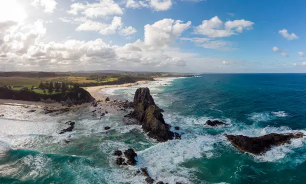 An aerial shot in late summer afternoon of Glasshouse Rocks Beach near Narooma, NSW, Australia