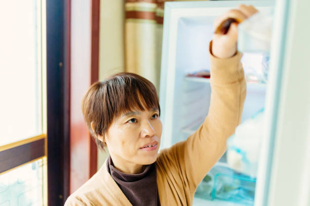 istock A middle-aged woman opened the refrigerator to look for something 1464749484