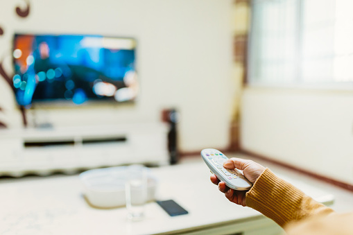 Middle-aged women watch TV at home - simple lifestyle