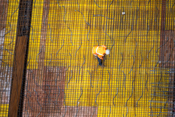 istock Top view of workers preparing a concrete foundation plate at a construction site. 1464752907