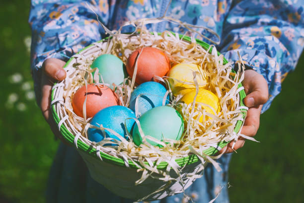 istock Colorful Easter eggs in basket. Kids hunt for eggs outdoors. 1464754660