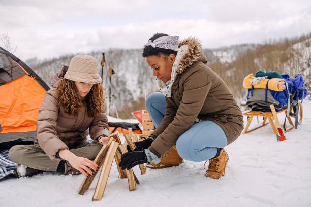 istock Friends warming up by the fire on camping 1464754818