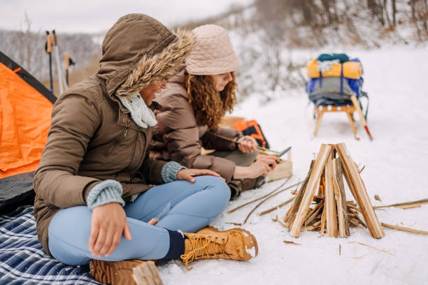 istock Friends warming up by the fire on camping 1464754827