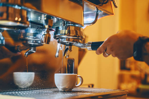 istock Professional coffee brewing in coffee shop. Barista make coffee cup from coffee machine in warm cozy atmosphere in small cafe. 1464754876