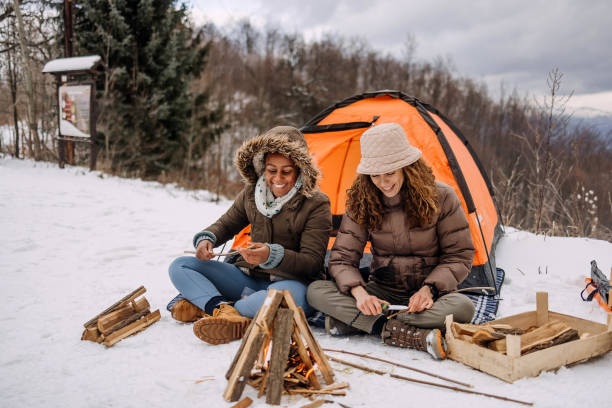 istock Friends warming up by the fire on camping 1464754934