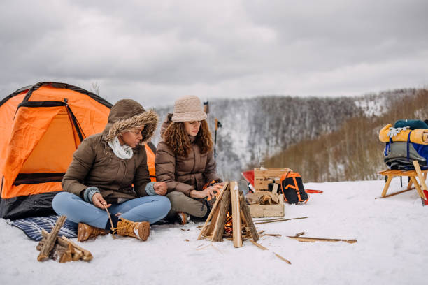 istock Friends warming up by the fire on camping 1464754936