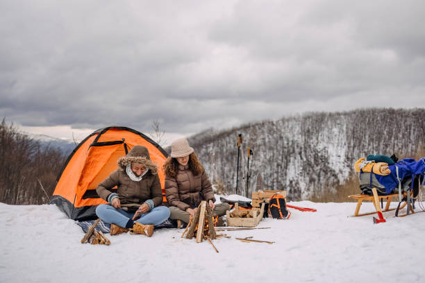 istock Friends warming up by the fire on camping 1464754989