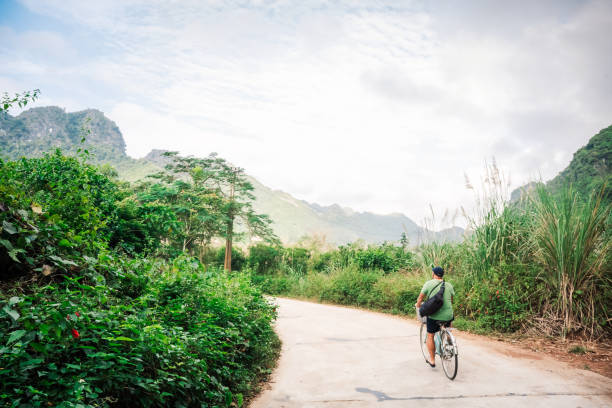istock man on bicycle tour on Cat Ba Island, Vietnam 1464756418