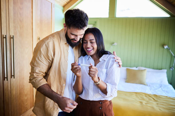 Ecstatic couple waiting for the results from a home pregnancy test - fotografia de stock