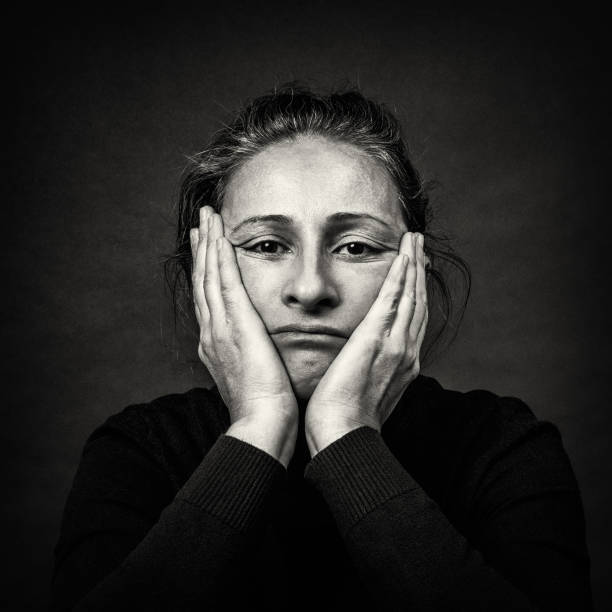istock Sad Woman with Hands Over Her Head in Black and White 1464756712