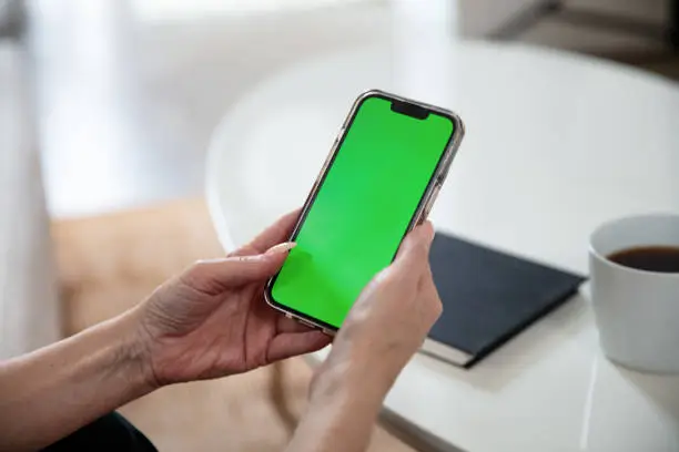 iPhone with green screen in loft