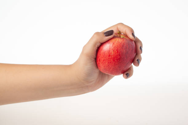 istock Hand holding whole red apple isolated on white background 1464756899