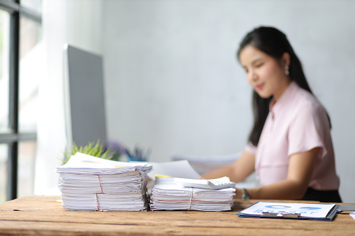 Close-up of company financial reports on secretary desk.