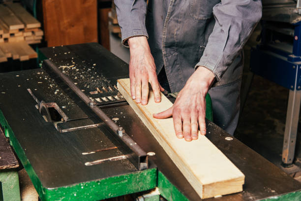 istock Work on woodworking machines and saws in a furniture workshop 1464758096