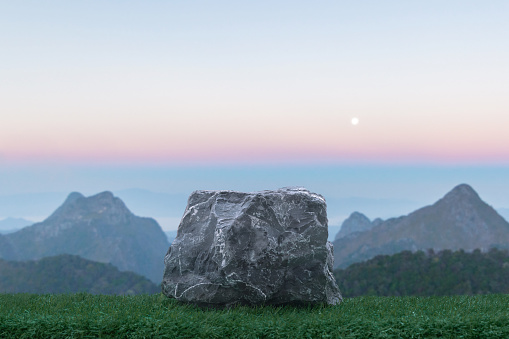 Stone podium table top with outdoor mountains pink pastel color scene nature landscape at sunrise blur background.Natural beauty cosmetic or healthy product placement presentation pedestal display.