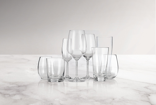 Glass cups set on a white marble kitchen countertop