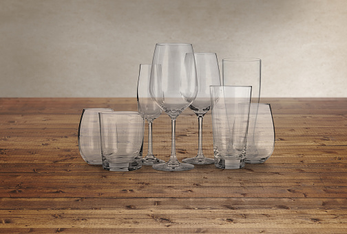 Glass cups set on a wood kitchen countertop