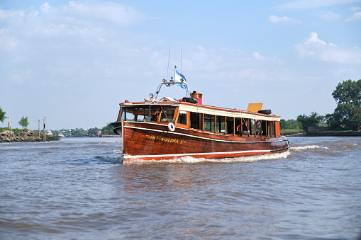Tigre, Buenos Aires, Argentina, Jan 11 2022: collective boat that serves as a mode of transport between the islands of the delta and makes sightseeing tours.