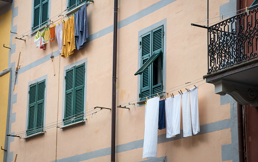 Residential House balconies, Green windows, Laundry outdoor. Lucca Italy