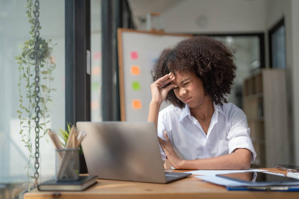 istock Feeling tired and stressed, workload, burnout, and fatigue. Frustrated young African American woman keeping eyes closed and massaging nose after working at a laptop for a long time in office 1464762874