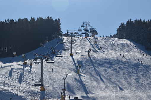 View of the ski slope and lift in the mountains of the winter in Winterberg, Germany