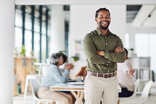 Business, black man and portrait with arms crossed of manager, leadership or trust. Smile, happy and male boss in startup agency for success, employee motivation and vision of executive company goals