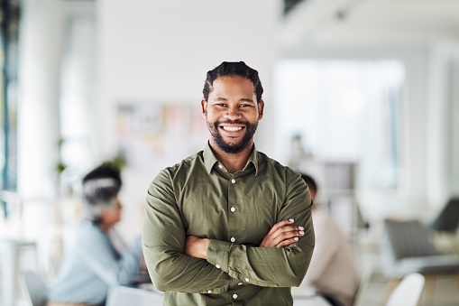 Business, black man and portrait with arms crossed for leadership, management and trust. Smile, happiness and male manager in startup agency with confidence, motivation or professional work goals