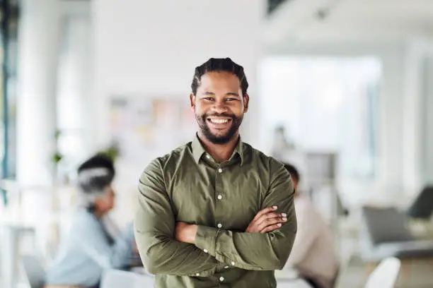 Photo of Business, black man and portrait with arms crossed for leadership, management and trust. Smile, happiness and male manager in startup agency with confidence, motivation or professional work goals