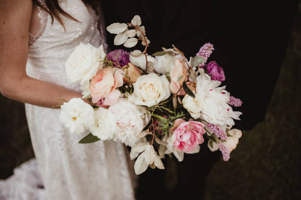 istock Bride and groom holding bouquet 1464765640