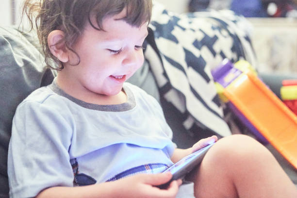 istock Toddler playing with a smartphone 1464766214
